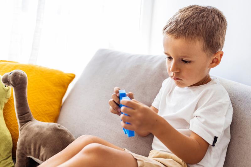 a child hyperfocusing on blocks in his hand