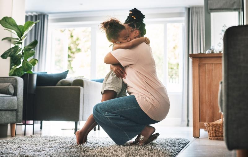 an anxious child hugging her mom